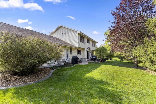 2425 Sandstone Ct, Oshkosh, WI 54904 - back of house with a yard and a patio area