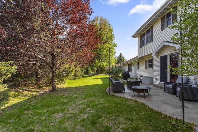 2425 Sandstone Ct, Oshkosh, WI 54904 - view of grassy yard featuring a patio and a fire pit