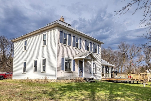 N9003 County Road Vv, Mindoro, WI 54644 - view of side of property featuring a chimney, a yard, and a wooden deck