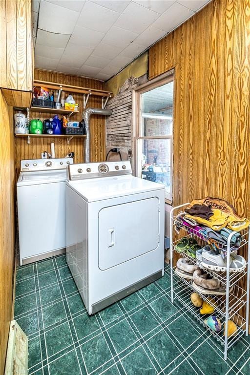 N9003 County Road Vv, Mindoro, WI 54644 - laundry room with wood walls, washing machine and clothes dryer, and dark flooring