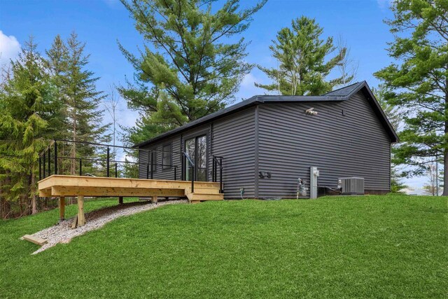 401 George St, Crivitz, WI 54114 - view of property exterior featuring central AC unit, a lawn, and a wooden deck