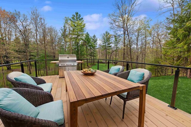 401 George St, Crivitz, WI 54114 - wooden deck with grilling area, a lawn, outdoor dining area, and a view of trees