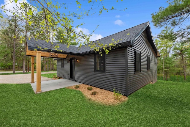401 George St, Crivitz, WI 54114 - back of house featuring roof with shingles, a lawn, and a patio area