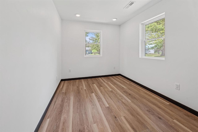 401 George St, Crivitz, WI 54114 - empty room with plenty of natural light, baseboards, and light wood-style floors