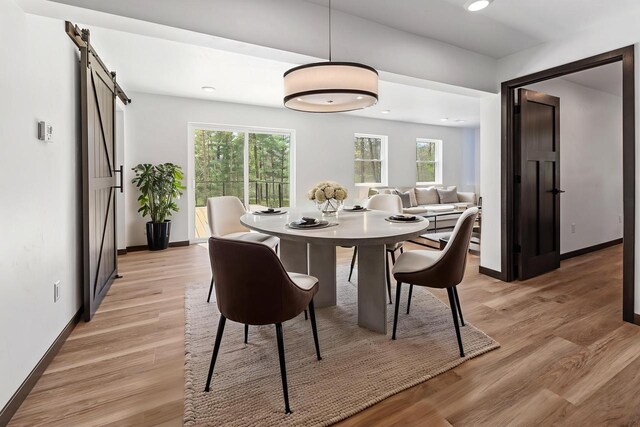 401 George St, Crivitz, WI 54114 - dining room with a barn door, baseboards, light wood-type flooring, and recessed lighting