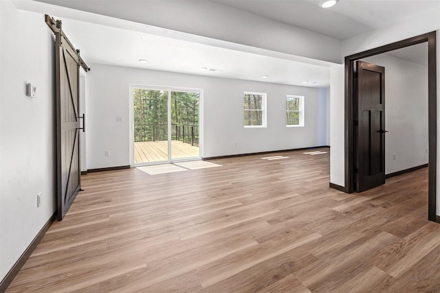 401 George St, Crivitz, WI 54114 - empty room featuring a barn door, baseboards, light wood finished floors, and recessed lighting