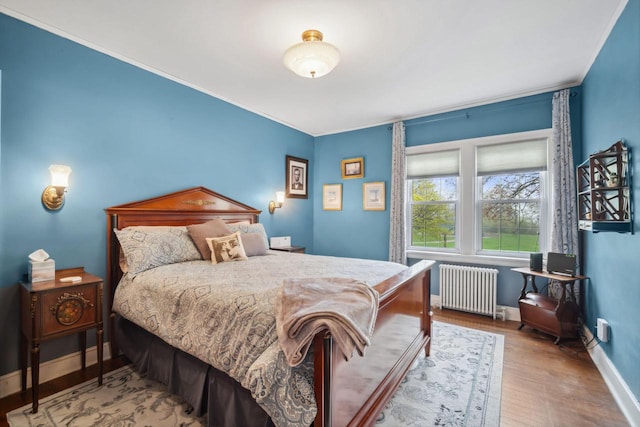 2017 N Terrace Ave, Milwaukee, WI 53202 - bedroom featuring radiator, wood finished floors, baseboards, and crown molding