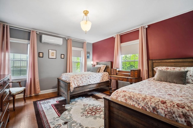 2017 N Terrace Ave, Milwaukee, WI 53202 - bedroom featuring a wall unit AC, wood finished floors, and baseboards