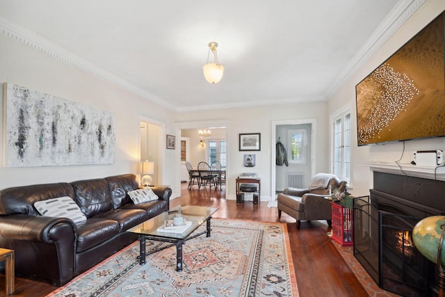 2017 N Terrace Ave, Milwaukee, WI 53202 - living area featuring a warm lit fireplace, wood finished floors, a chandelier, and ornamental molding