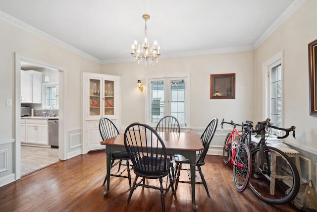 2017 N Terrace Ave, Milwaukee, WI 53202 - dining space featuring dark wood-style flooring, a chandelier, and crown molding
