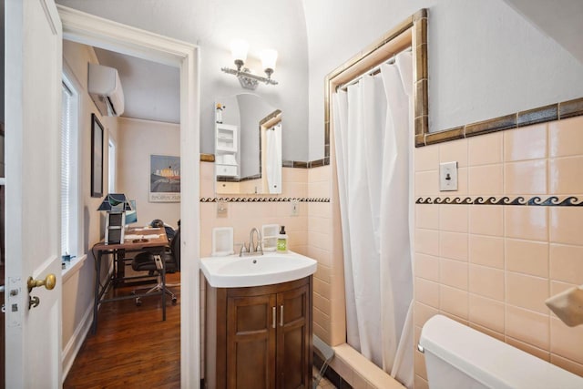 2017 N Terrace Ave, Milwaukee, WI 53202 - full bath with tile walls, an AC wall unit, toilet, wood finished floors, and curtained shower
