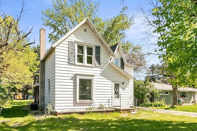 412 W Chestnut St, Pardeeville, WI 53954 - view of front of home featuring a front lawn and a chimney