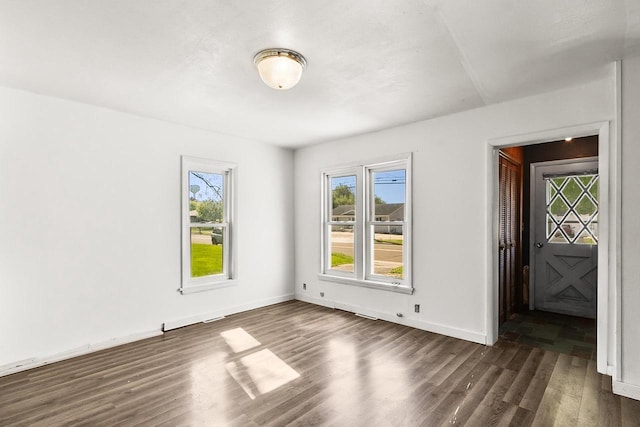 412 W Chestnut St, Pardeeville, WI 53954 - empty room featuring dark wood-type flooring and baseboards