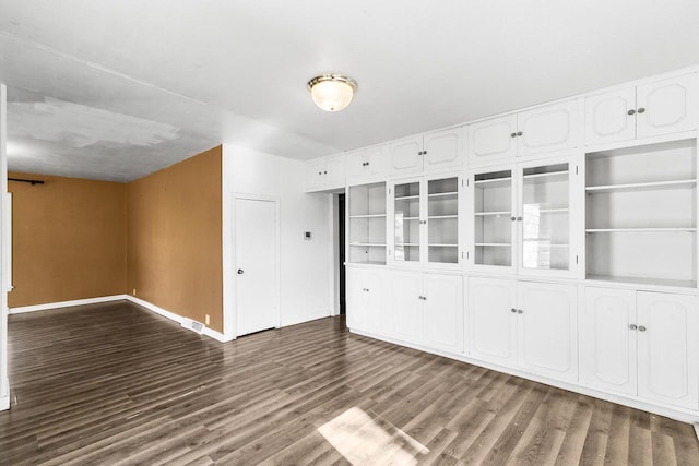 412 W Chestnut St, Pardeeville, WI 53954 - empty room with dark wood-type flooring and baseboards
