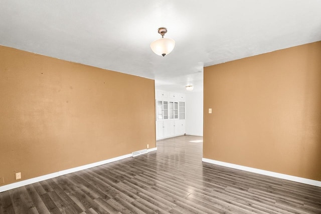 412 W Chestnut St, Pardeeville, WI 53954 - empty room featuring dark wood-type flooring and baseboards