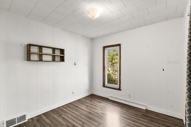 412 W Chestnut St, Pardeeville, WI 53954 - empty room with a baseboard radiator, dark wood-style floors, and baseboards