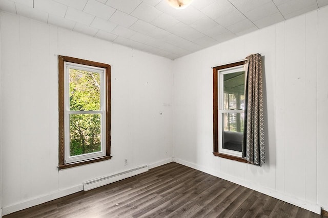 412 W Chestnut St, Pardeeville, WI 53954 - unfurnished room featuring a baseboard radiator, dark wood-style flooring, and baseboards