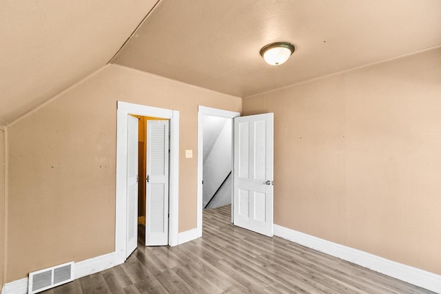 412 W Chestnut St, Pardeeville, WI 53954 - additional living space with baseboards, wood finished floors, and lofted ceiling