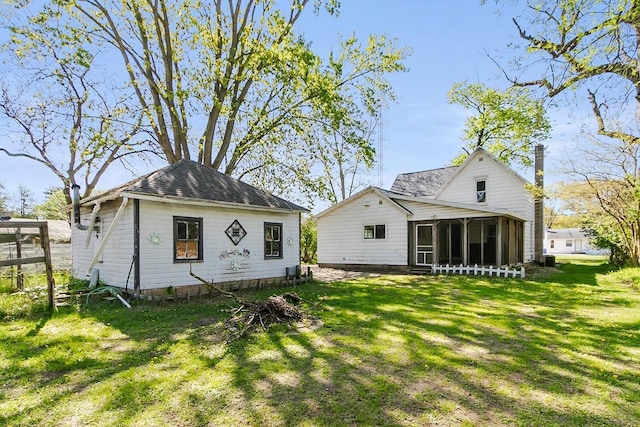 412 W Chestnut St, Pardeeville, WI 53954 - back of property featuring a sunroom, a lawn, and central AC unit
