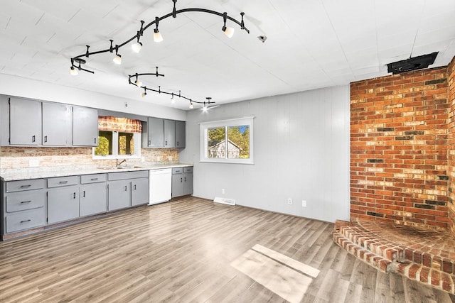412 W Chestnut St, Pardeeville, WI 53954 - kitchen with gray cabinets, white dishwasher, a sink, track lighting, and light wood finished floors