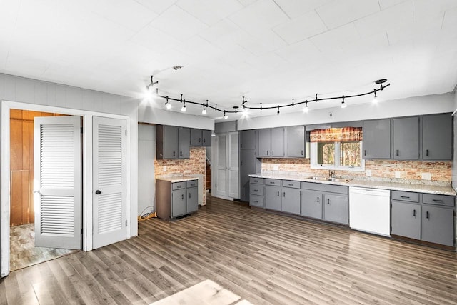 412 W Chestnut St, Pardeeville, WI 53954 - kitchen featuring gray cabinetry, white dishwasher, wood finished floors, and a sink
