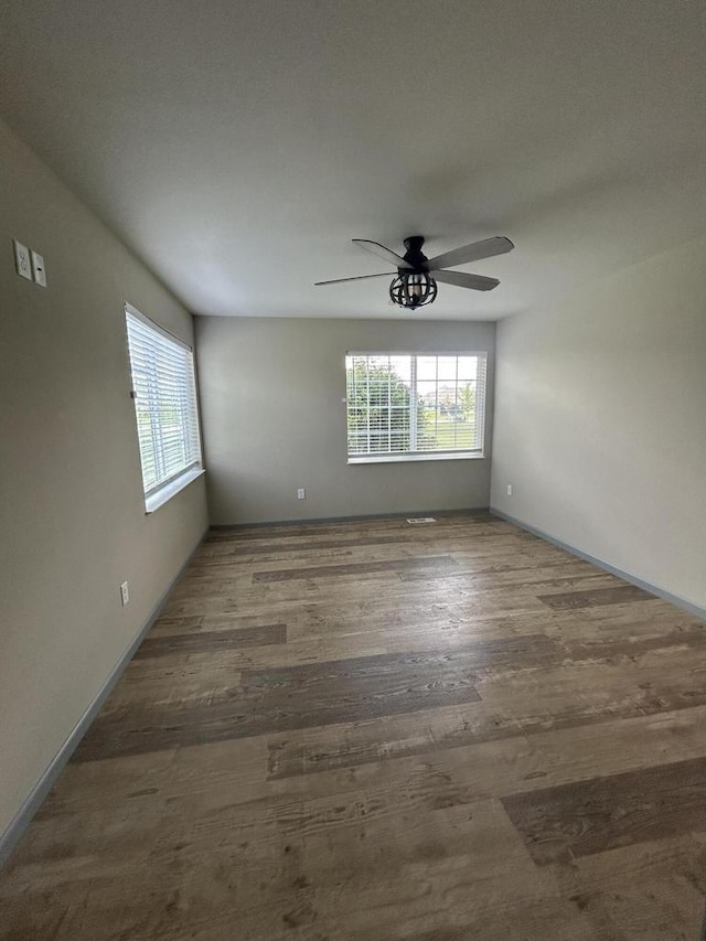 1341 S Wilson Ave Unit 10-4, Hartford, WI 53027 - unfurnished room featuring healthy amount of natural light, a ceiling fan, wood finished floors, and baseboards