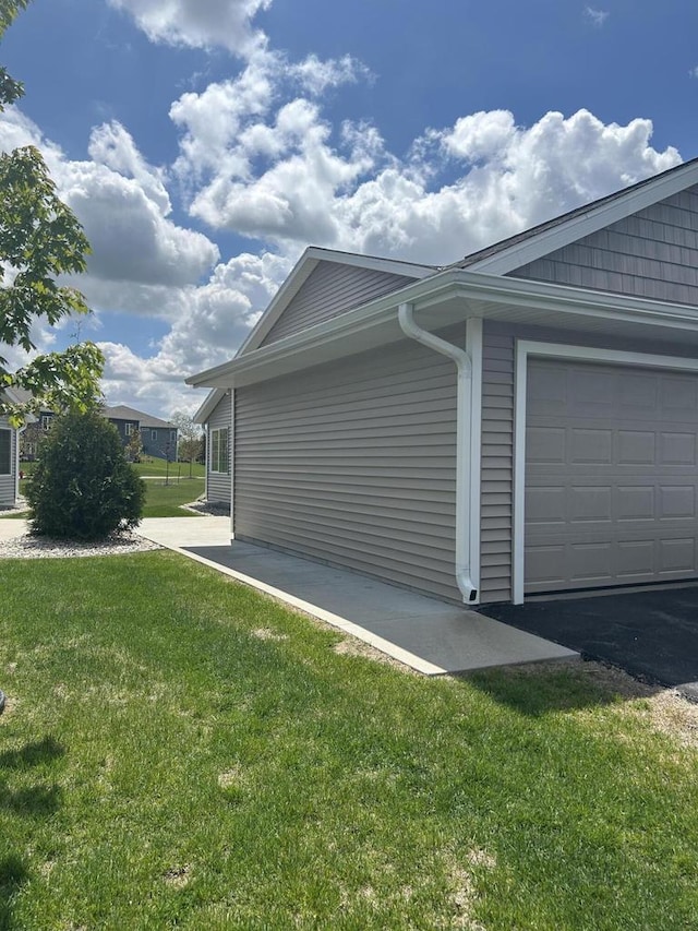 1341 S Wilson Ave Unit 10-4, Hartford, WI 53027 - view of side of home featuring a lawn and a garage