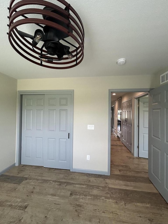 1341 S Wilson Ave Unit 10-4, Hartford, WI 53027 - unfurnished bedroom with baseboards, wood finished floors, and a closet