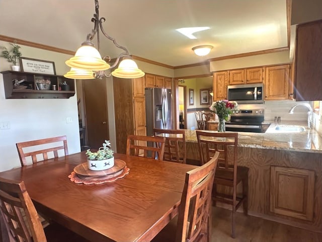 729 Parkway Dr, Mount Horeb, WI 53572 - dining area featuring ornamental molding and wood finished floors