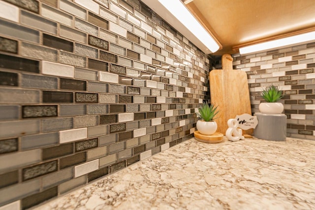 detailed view of tasteful backsplash and light stone counters