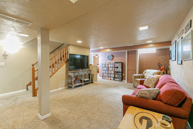 carpeted living room featuring stairway, baseboards, and a textured ceiling