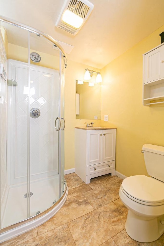 full bath featuring baseboards, toilet, a stall shower, and vanity