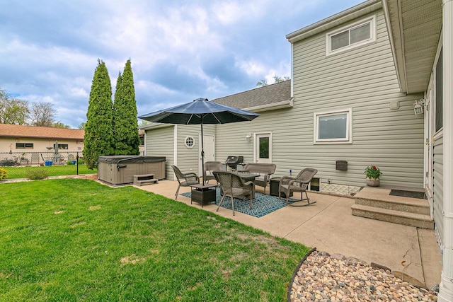 back of house featuring a hot tub, a patio area, and roof with shingles
