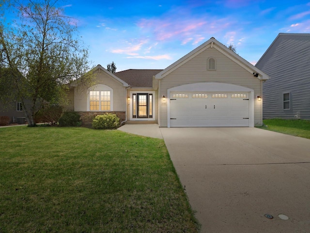 1537 Whitewater Dr, West Bend, WI 53095 - ranch-style house with an attached garage, driveway, and a yard