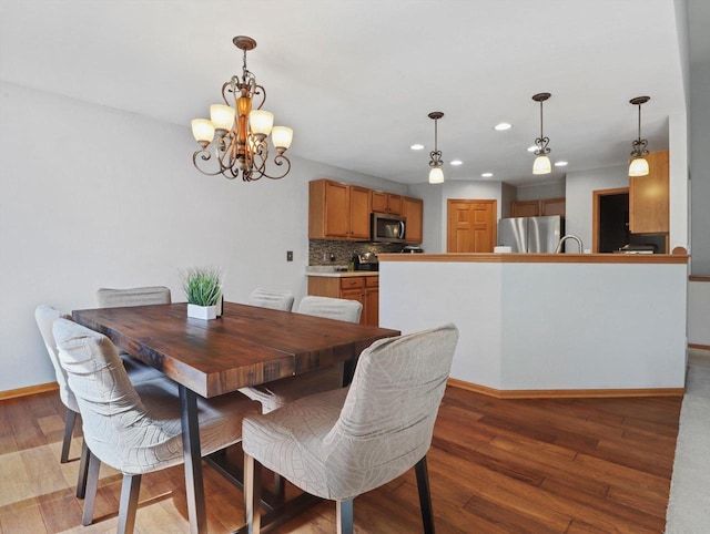 1537 Whitewater Dr, West Bend, WI 53095 - dining area with recessed lighting, light wood-style flooring, a chandelier, and baseboards