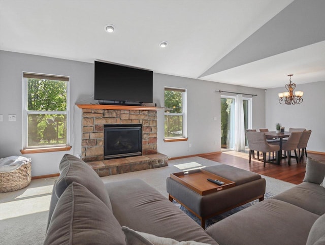 1537 Whitewater Dr, West Bend, WI 53095 - living room with a chandelier, baseboards, plenty of natural light, a fireplace, and lofted ceiling