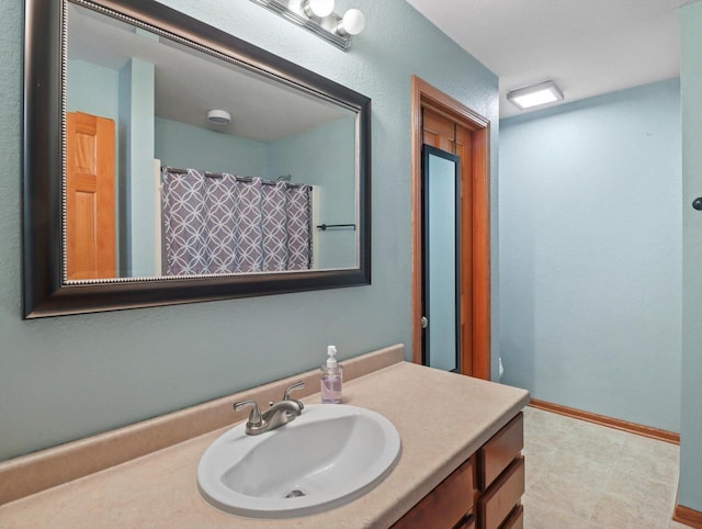 1537 Whitewater Dr, West Bend, WI 53095 - full bathroom with vanity, baseboards, and a shower with curtain