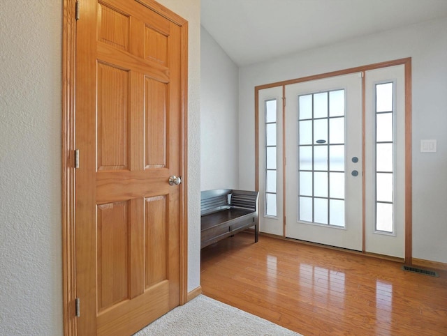 1537 Whitewater Dr, West Bend, WI 53095 - doorway featuring a textured wall, wood finished floors, plenty of natural light, and baseboards