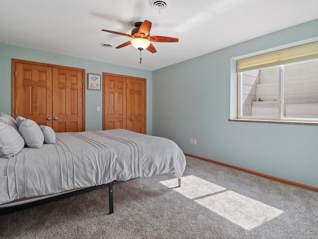 1537 Whitewater Dr, West Bend, WI 53095 - carpeted bedroom with multiple closets, baseboards, and a ceiling fan