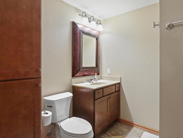 1537 Whitewater Dr, West Bend, WI 53095 - bathroom featuring a textured wall, toilet, and vanity