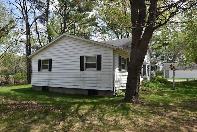 1118 E Pearl St, Neshkoro, WI 54960 - view of side of home featuring a yard and a shingled roof