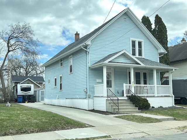 view of front of property featuring covered porch, a storage unit, a chimney, an outdoor structure, and roof with shingles
