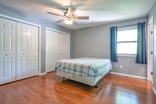 1725 Algonquin Dr, Baraboo, WI 53913 - bedroom with multiple closets, wood-type flooring, baseboards, and ceiling fan