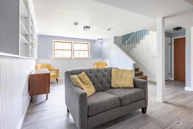 1725 Algonquin Dr, Baraboo, WI 53913 - living room featuring stairway, wood finished floors, a wainscoted wall, and baseboards