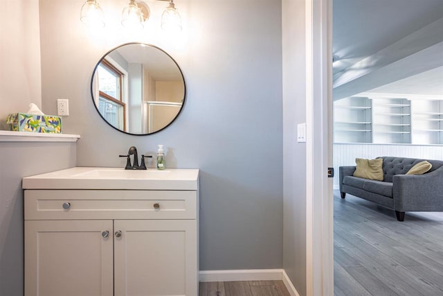 1725 Algonquin Dr, Baraboo, WI 53913 - bathroom with wood finished floors, vanity, and baseboards