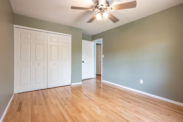 1725 Algonquin Dr, Baraboo, WI 53913 - unfurnished bedroom with baseboards, light wood-style floors, a closet, and a ceiling fan
