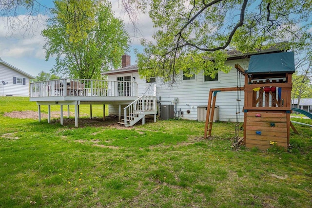 1725 Algonquin Dr, Baraboo, WI 53913 - back of house with a chimney, a yard, a deck, and a playground