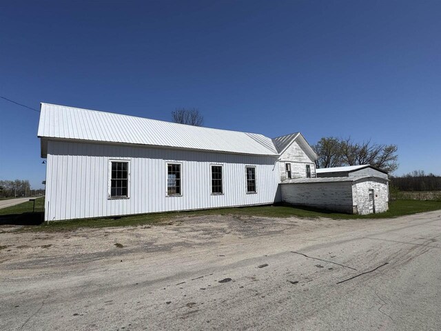 2897 County Road A, Oconto, WI 54153 - view of property exterior featuring metal roof and an outbuilding