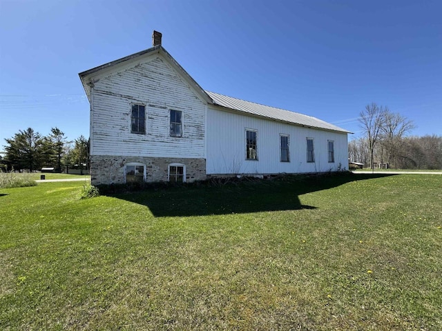2897 County Road A, Oconto, WI 54153 - view of side of home with a lawn, metal roof, and a chimney