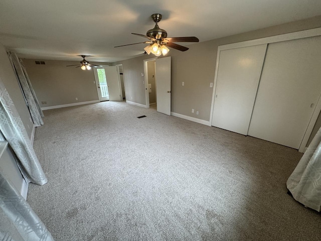 unfurnished bedroom featuring carpet, ceiling fan, and baseboards